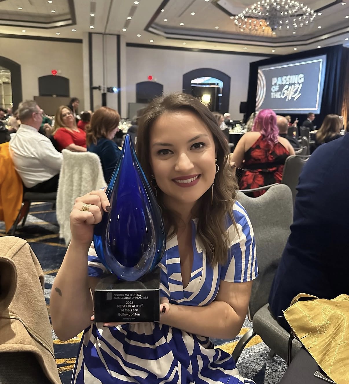 Bailey Jordan holding her 2023 NEFAR Realtor of the Year trophy at the awards ceremony